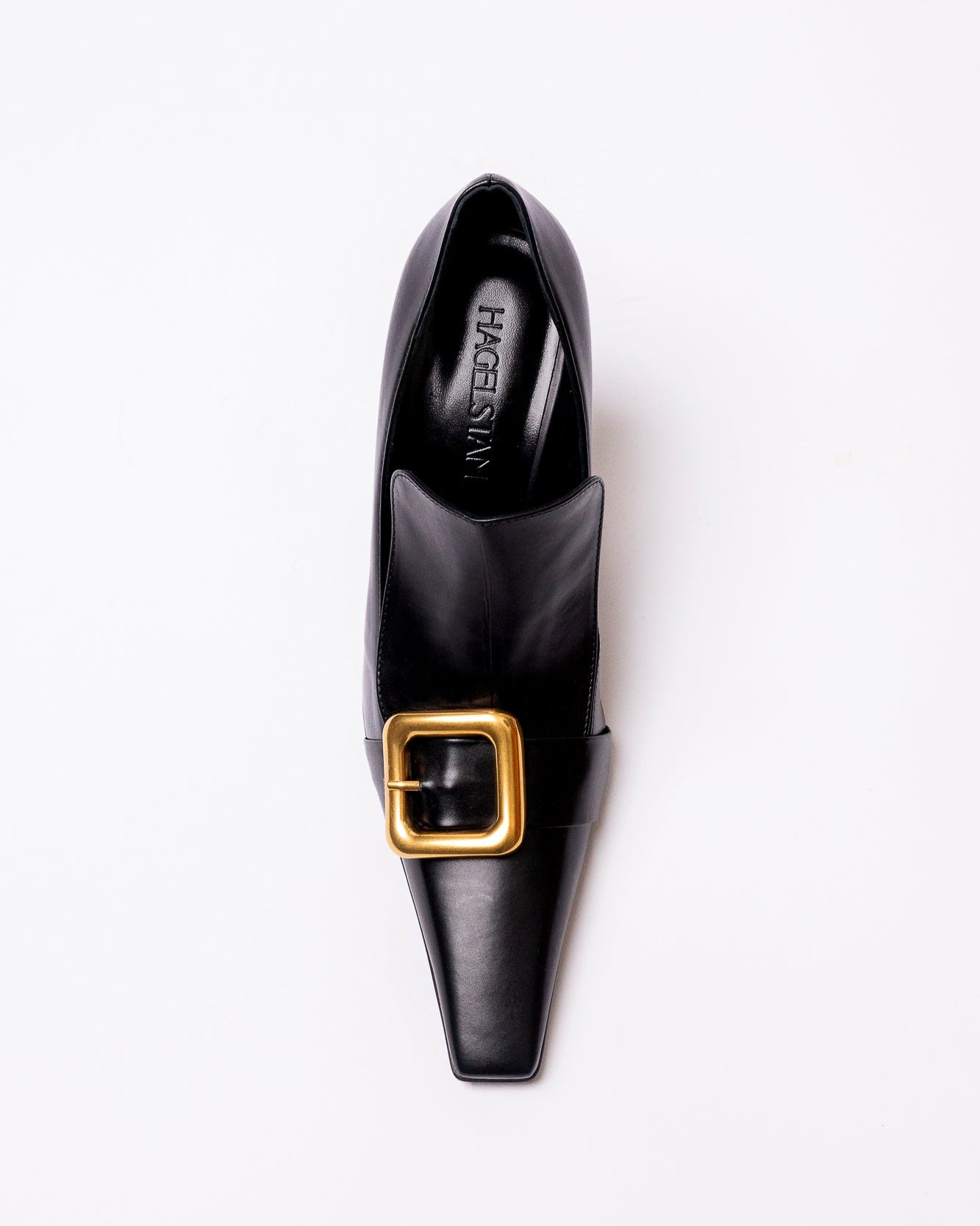 Black shoe with a gold buckle on a white background