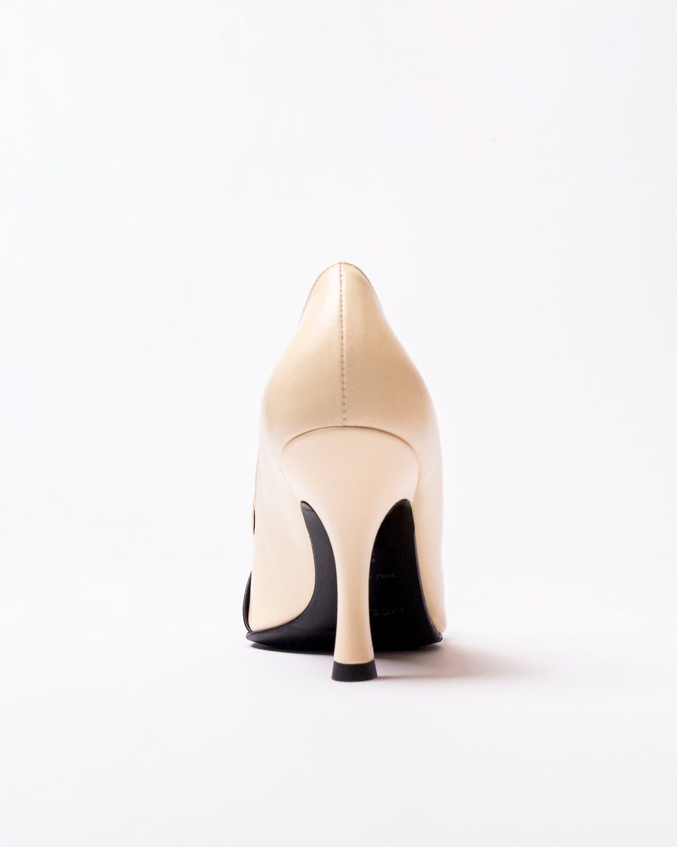 Beige high-heeled shoe on a white background