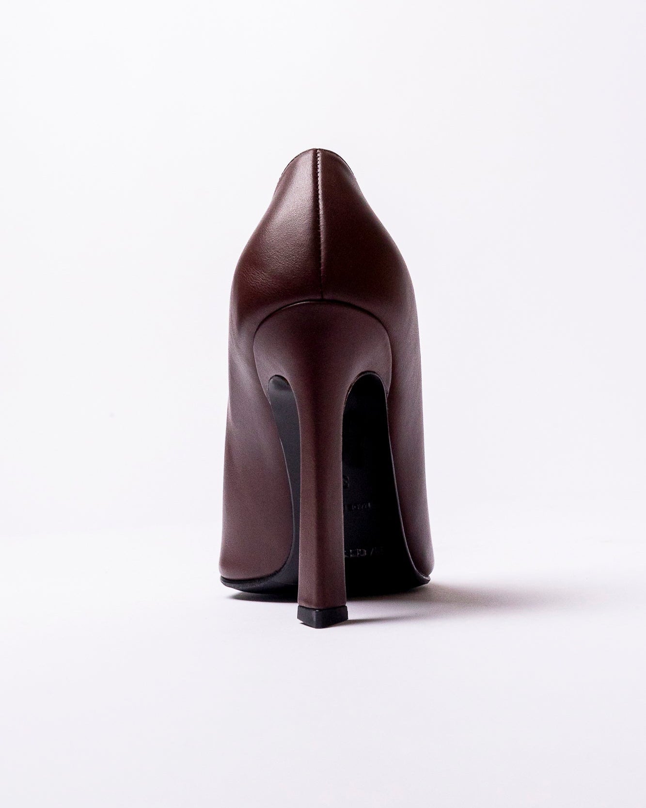 Brown high-heeled shoe on a white background
