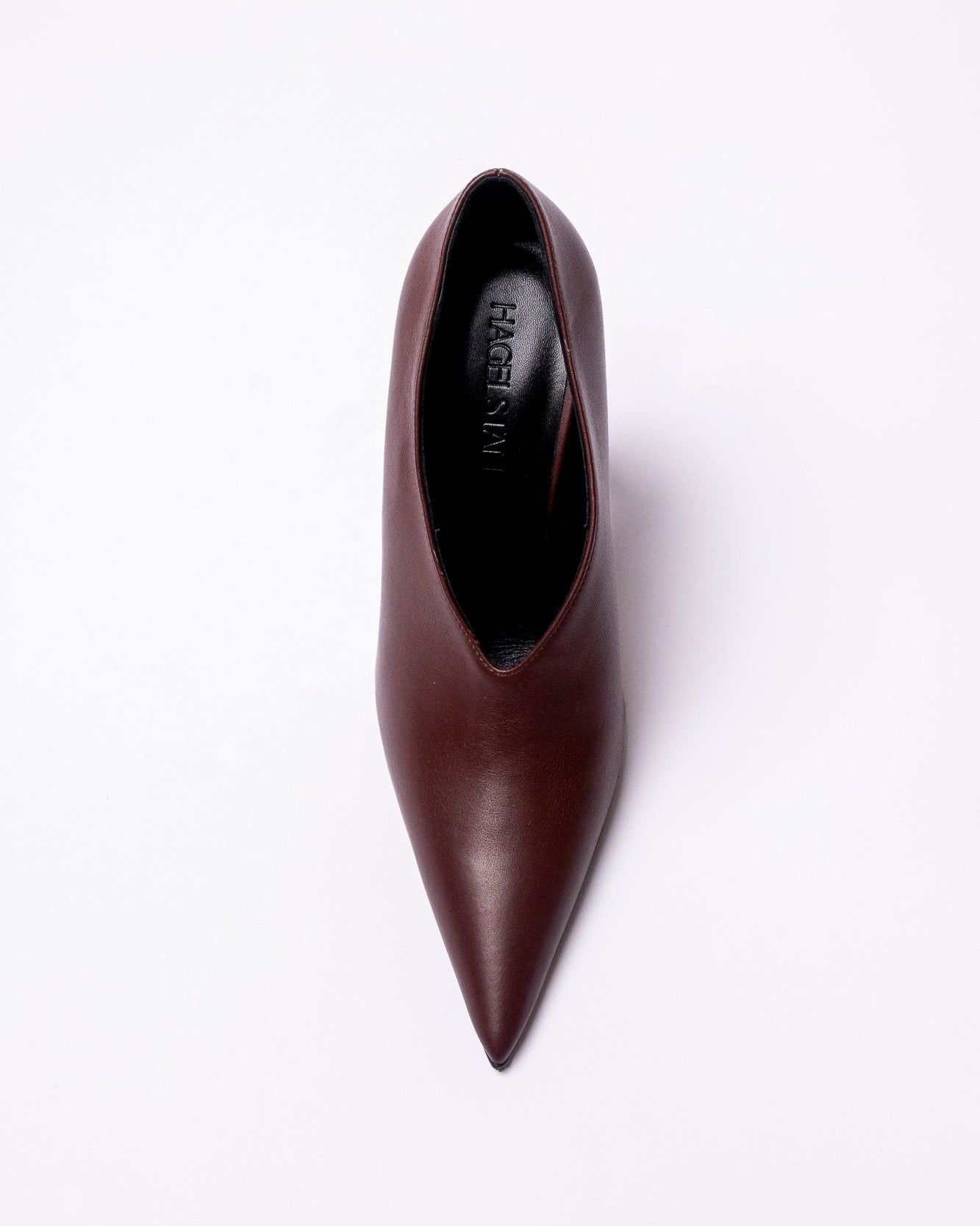 Brown pointed-toe shoe on a white background