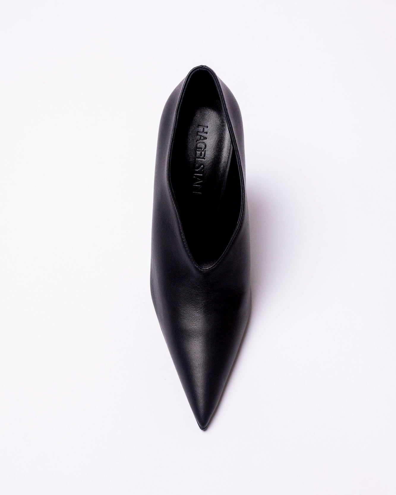 Black pointed-toe shoe on a white background