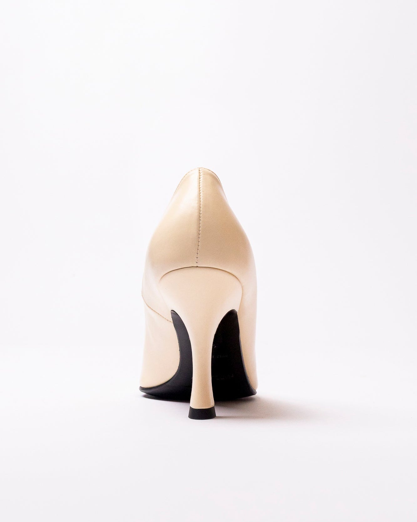 Beige high-heeled shoe on a white background
