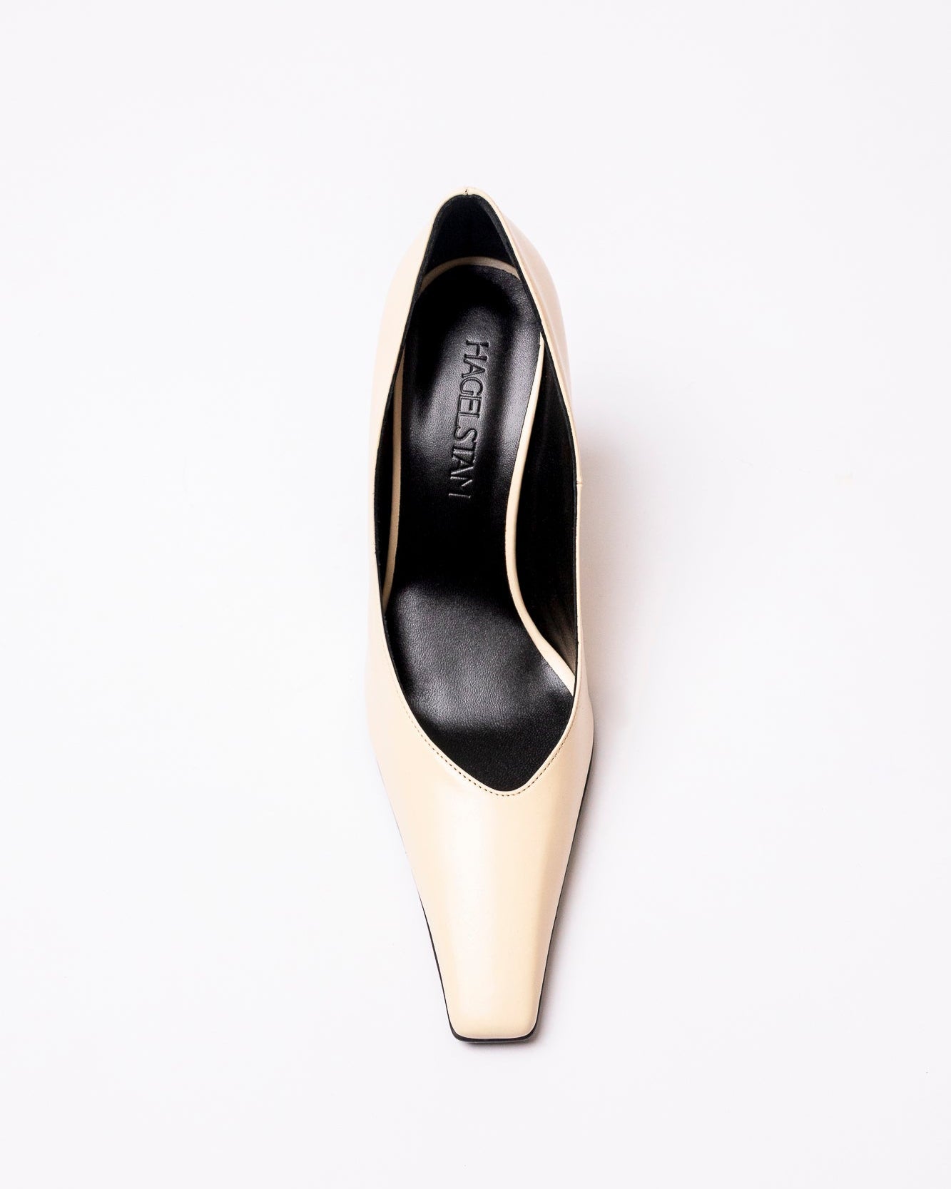 High-heeled shoe with black and gold design on a white background