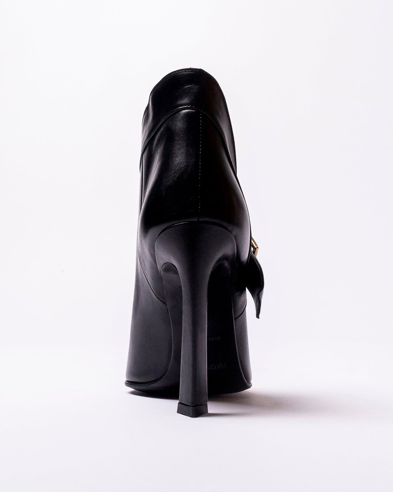Black high-heeled shoe on a white background