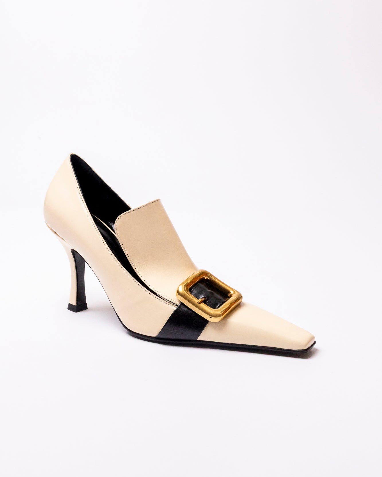 High-heeled shoe with a gold buckle on a white background