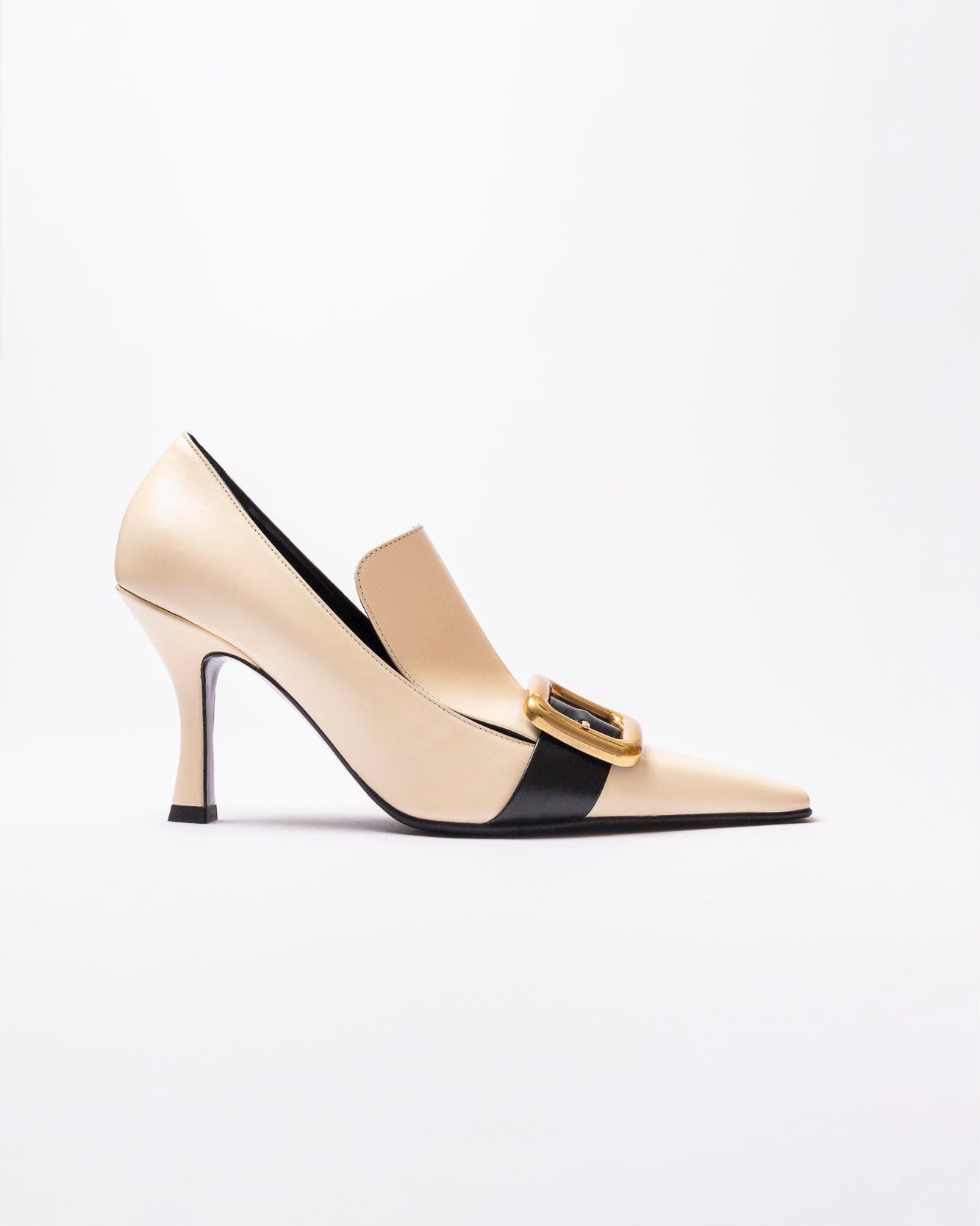 Beige high-heeled shoe with a black strap and gold buckle on a white background