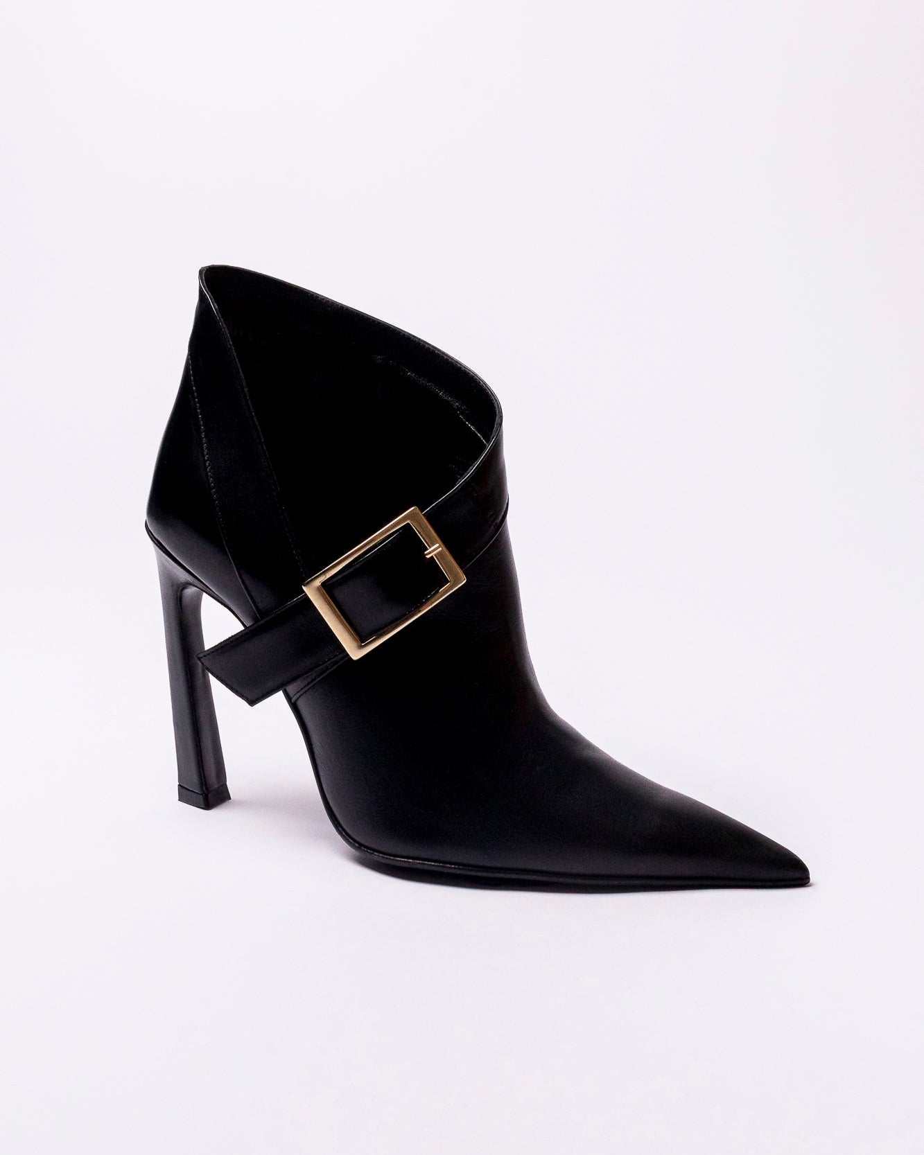 Black high-heeled boot with a gold buckle on a white background