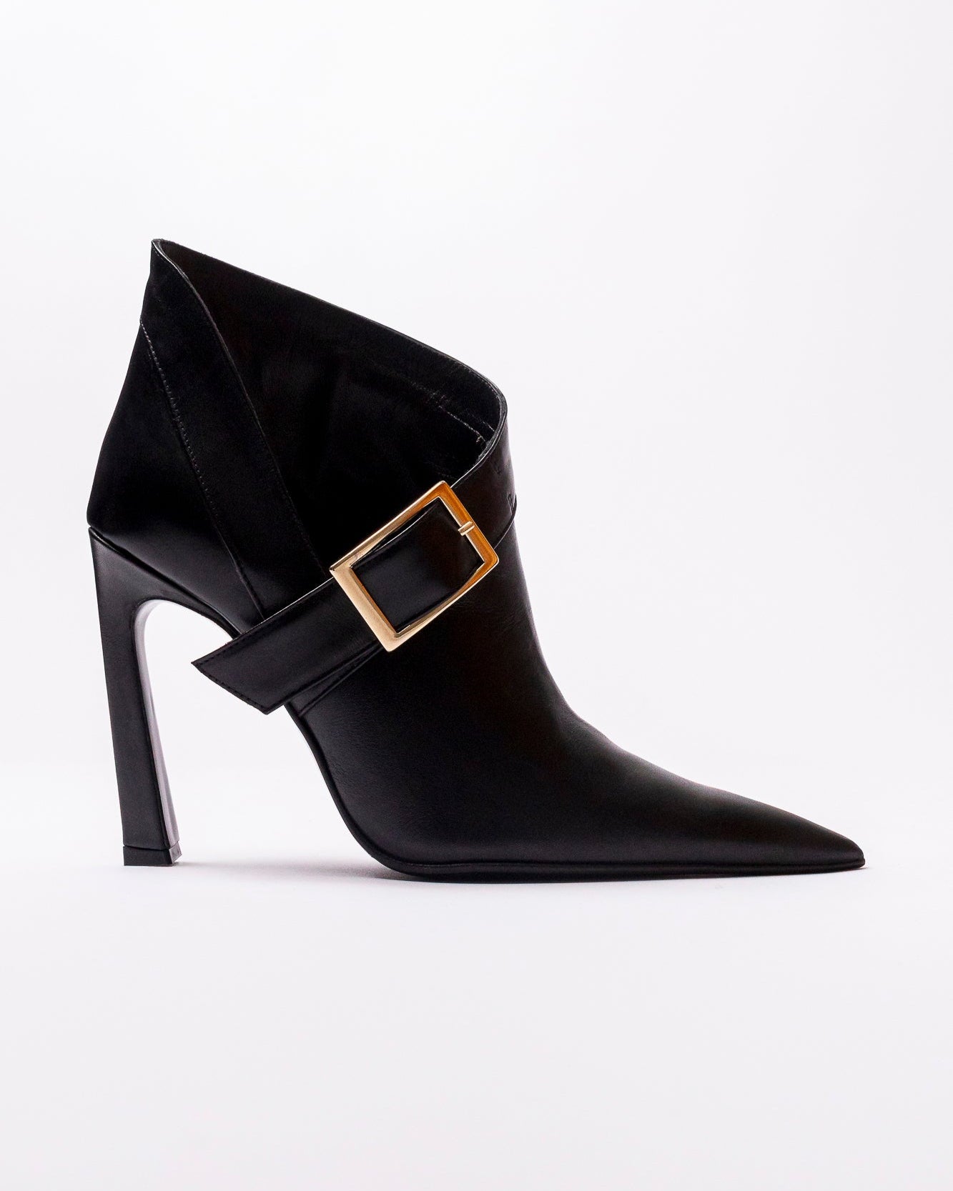 Black ankle boot with gold buckle on a white background