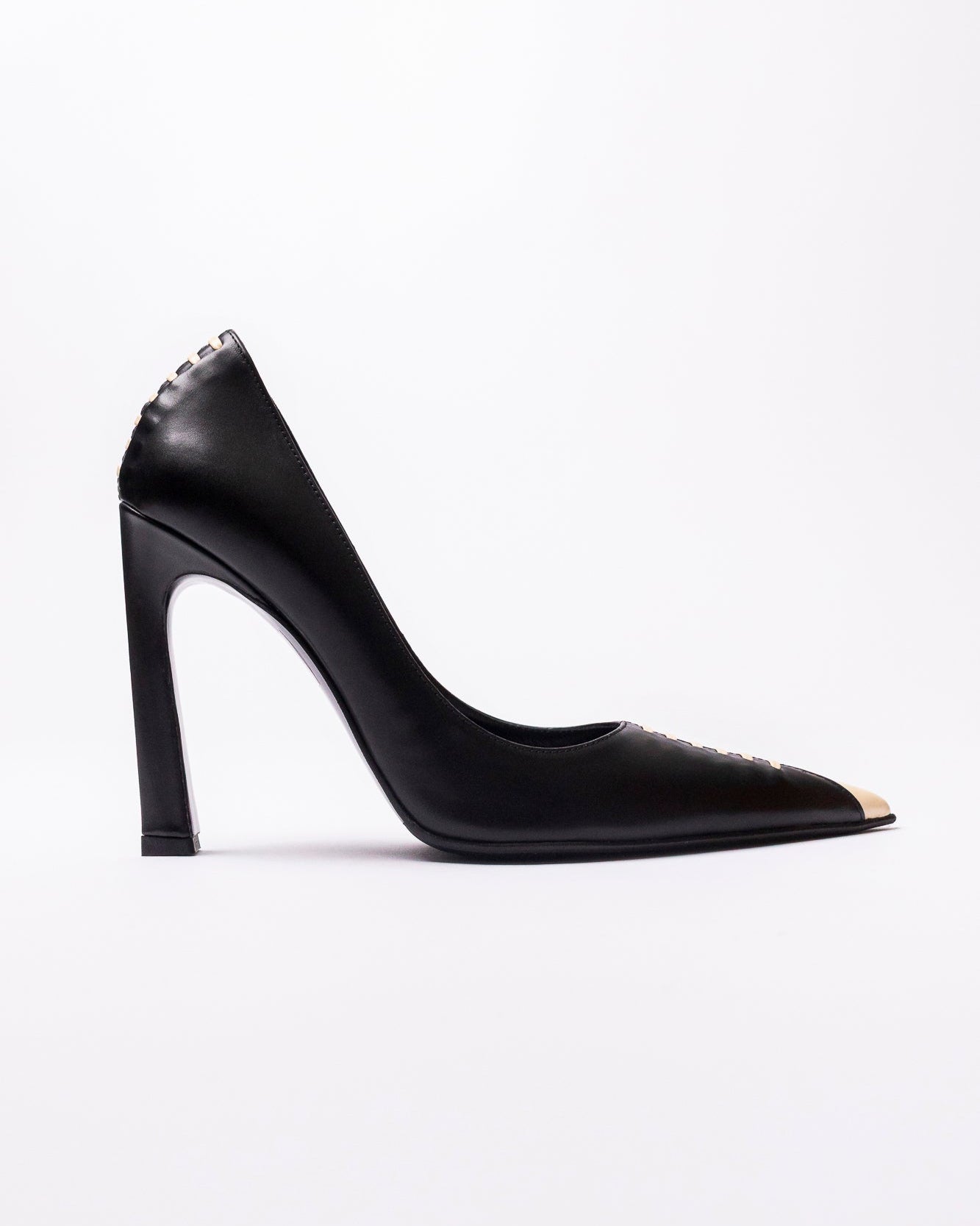 Black high-heeled shoe with decorative elements on a white background